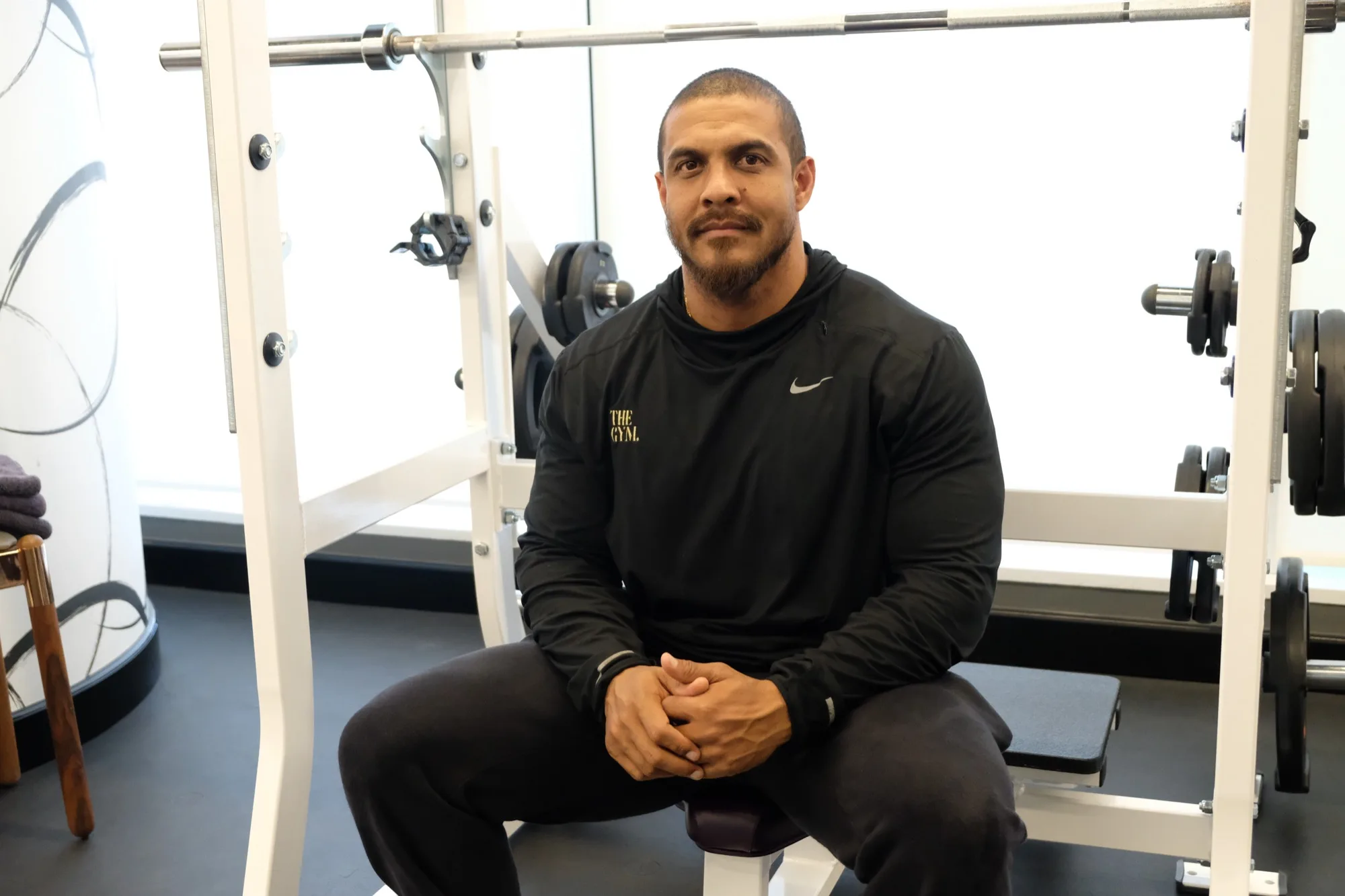 Hud Russell seated at a squat rack