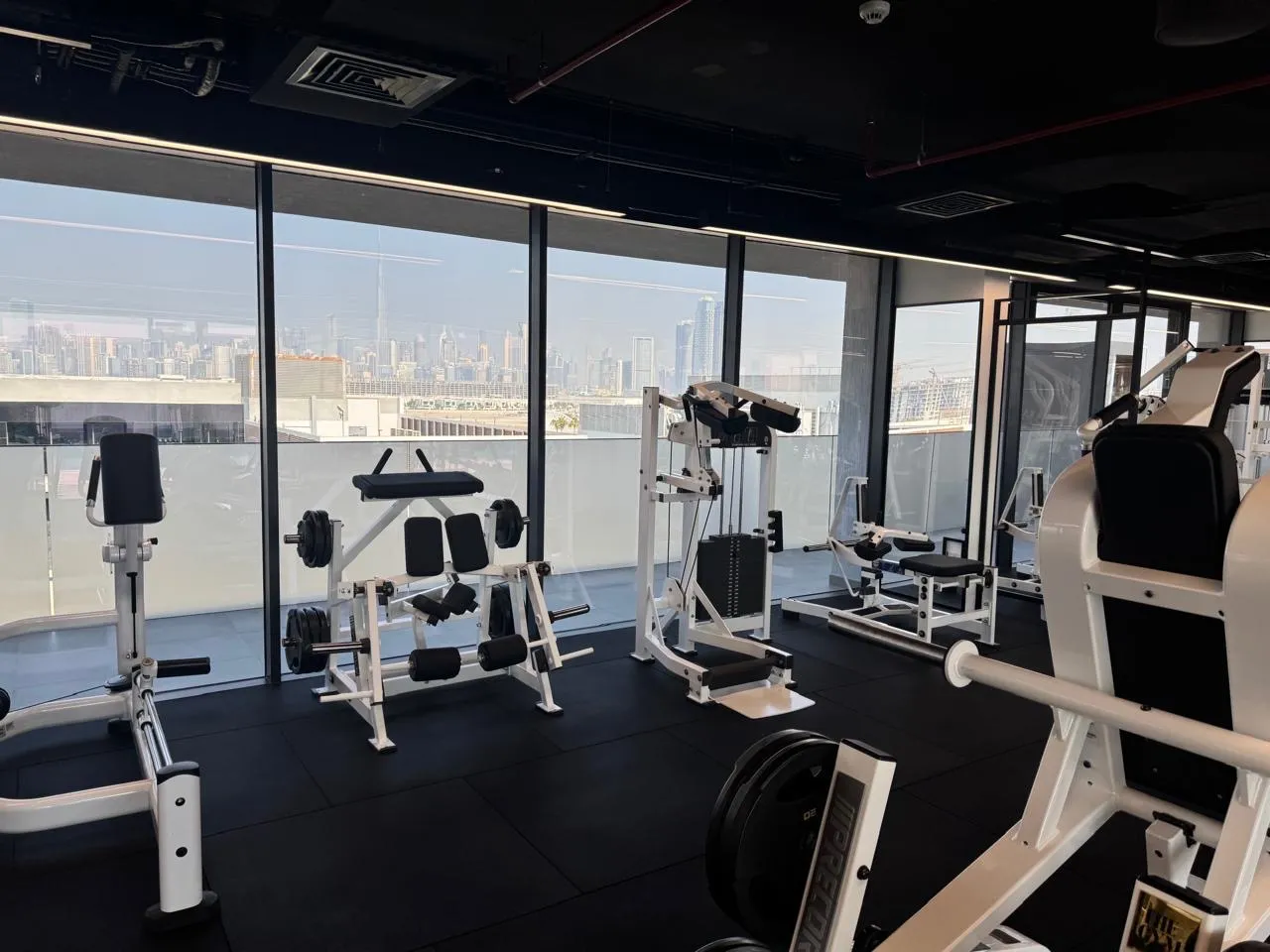 Machines framed by the Dubai skyline