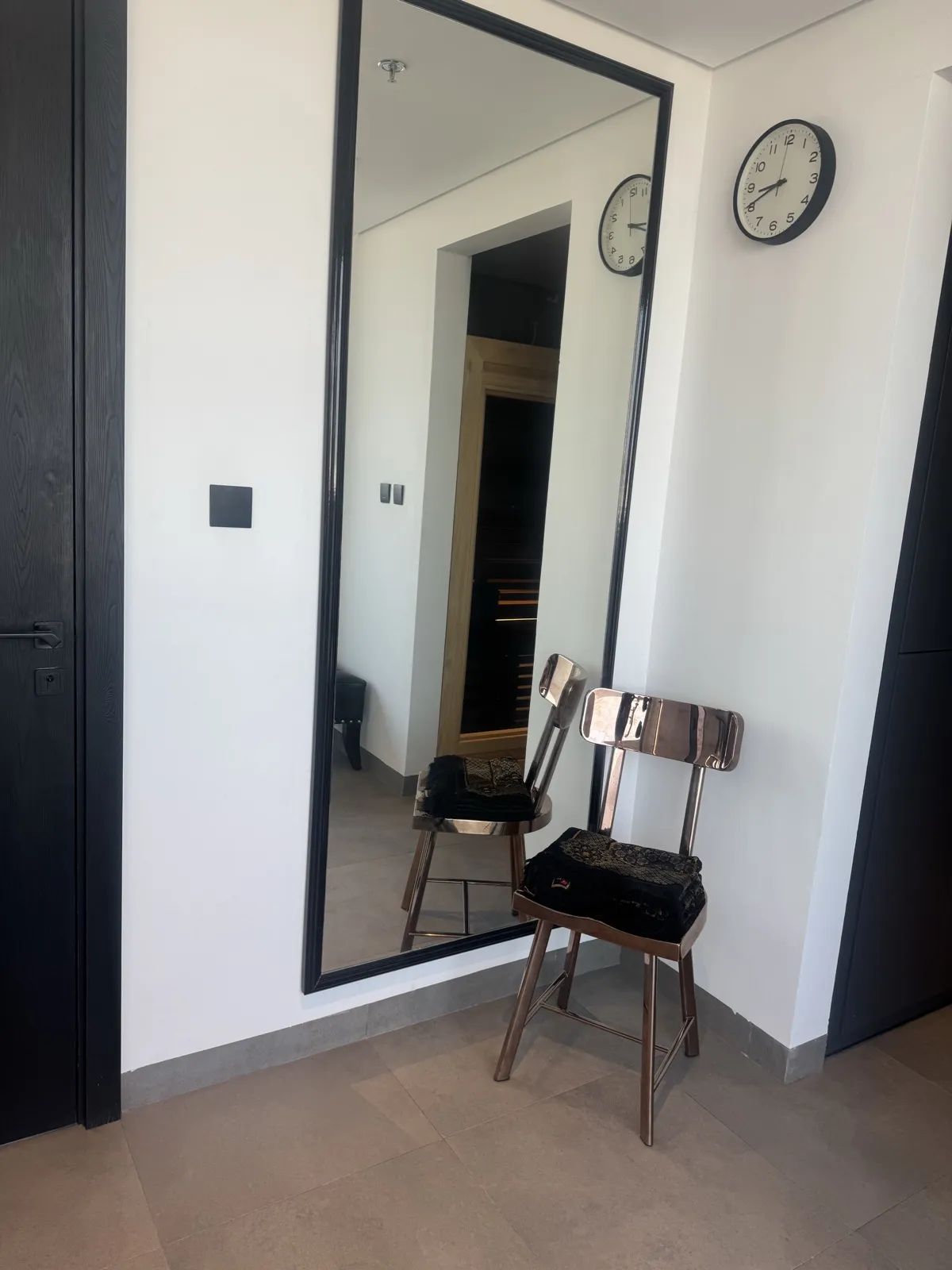 Full-length mirror and polished steel chair