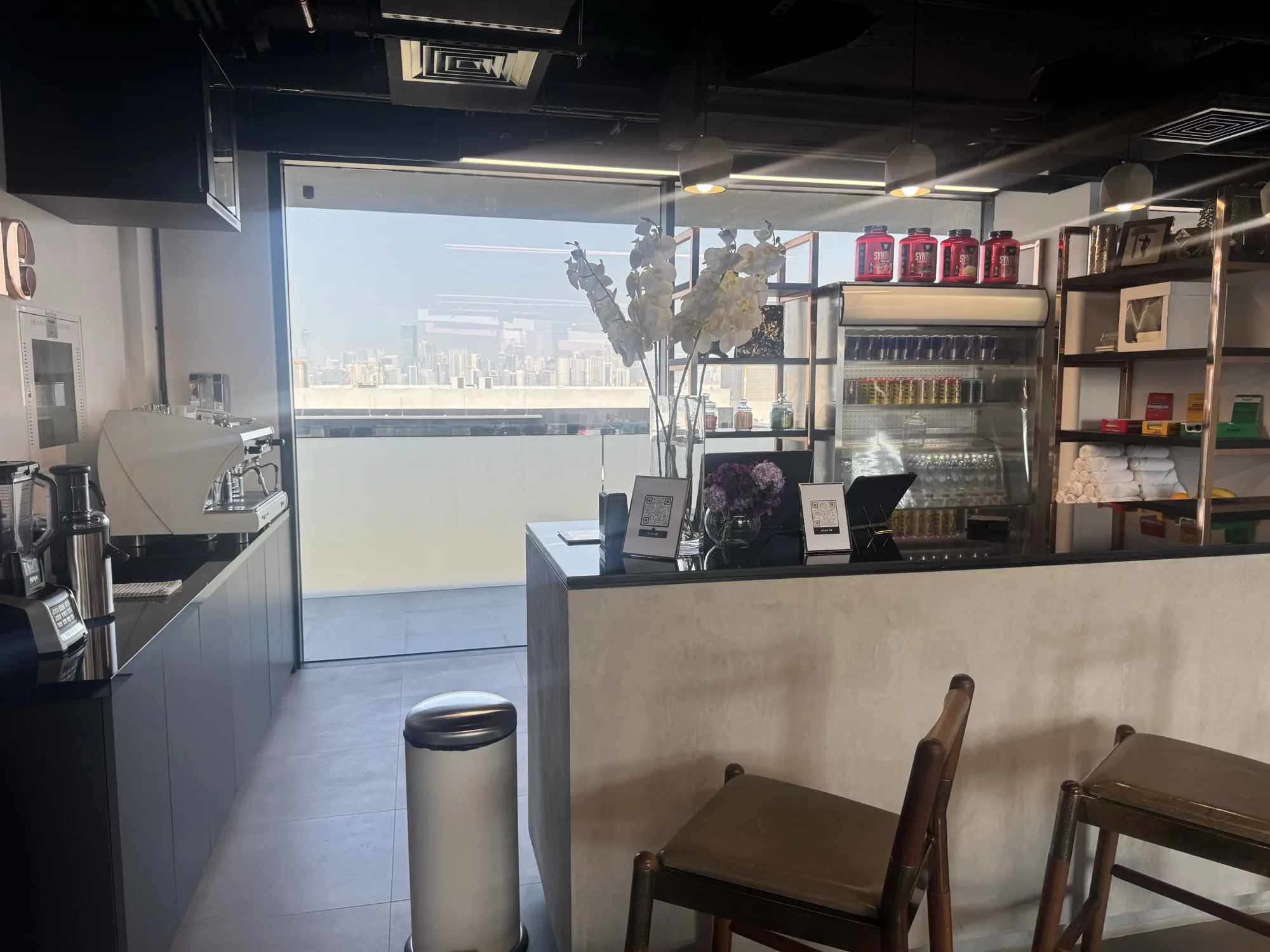 The Muscle Bar counter with stools and supplement shelves