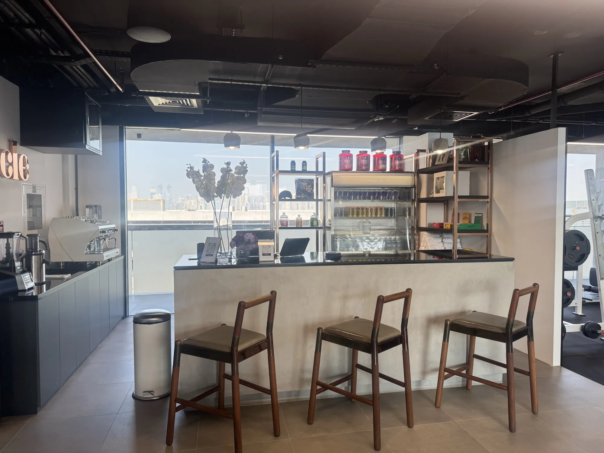 The Muscle Bar with stools, coffee machine and supplement shelves