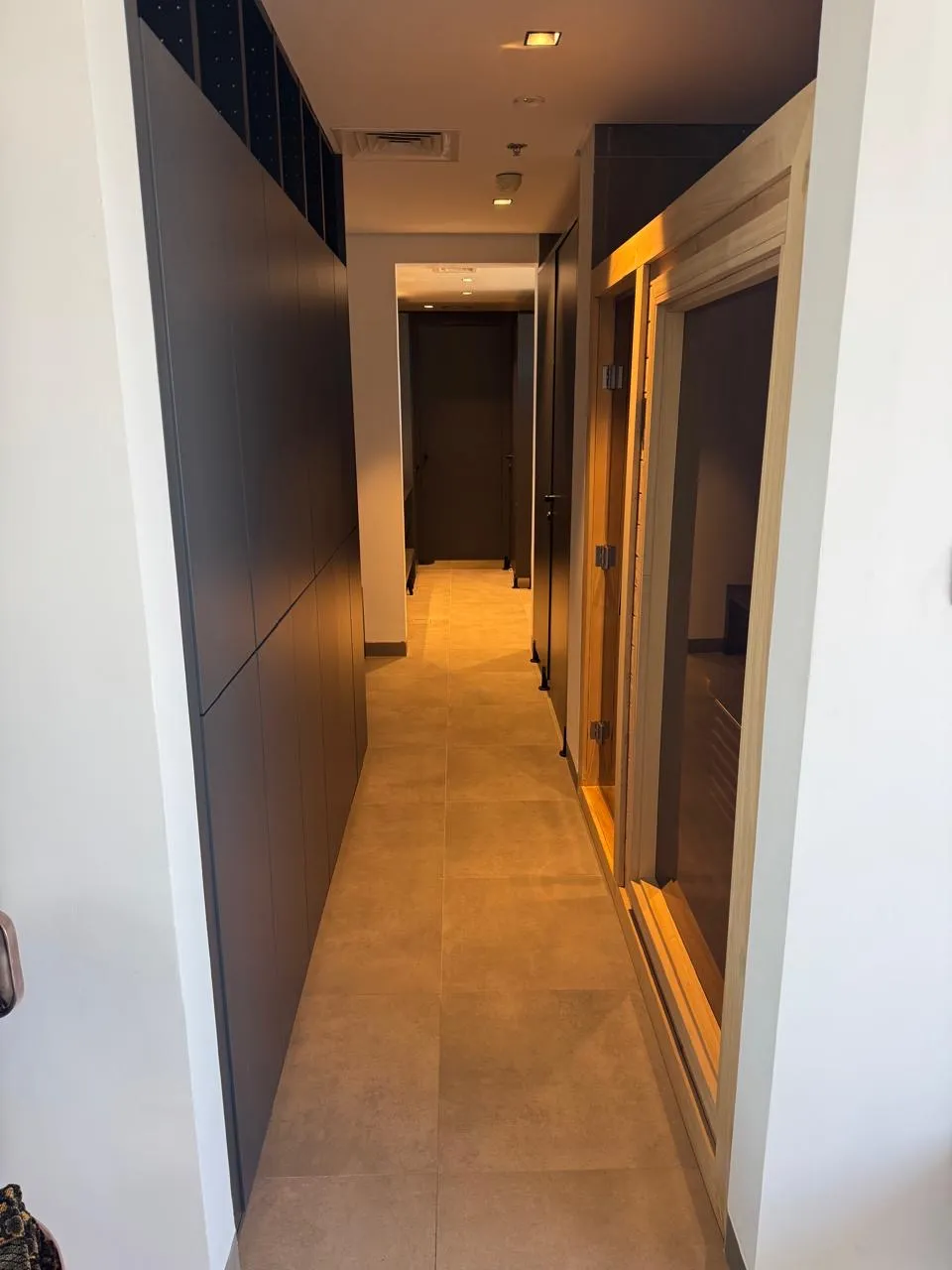 Warm-lit corridor to the sauna